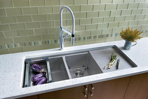 Oversized Sink with Glass Subway Tiles. Cabinets are Walnut , Countertop is Corian